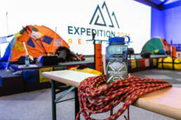 Everest Ropes and water bottle with tents in the background which teams will use within their Everest challenges