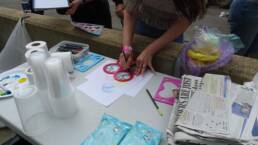 A girl is drawing shapes using a stencil