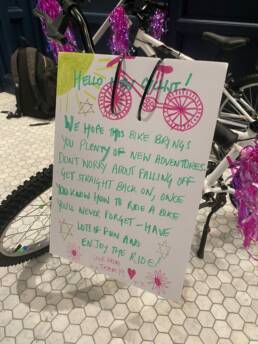 A bike for charity with a message on it, which reads Hello New Cyclist! We hope this bike brings you plenty of new adventures. Don't worry about falling off get straight back on, once you know how to ride a bike you never forget - have lots of fun and enjoy the ride