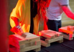 Woman playing blocks as part of the Qubed team building event